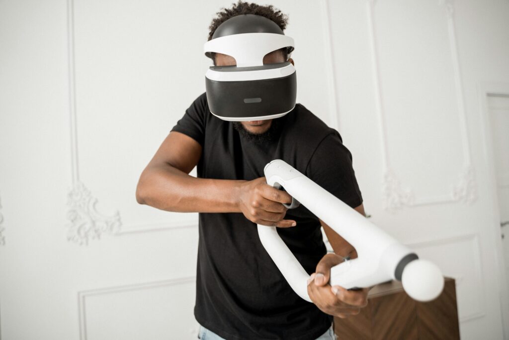 man wearing VR headset and holding VR game accessory